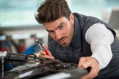 auto mechanic working in garage repair service © auremar