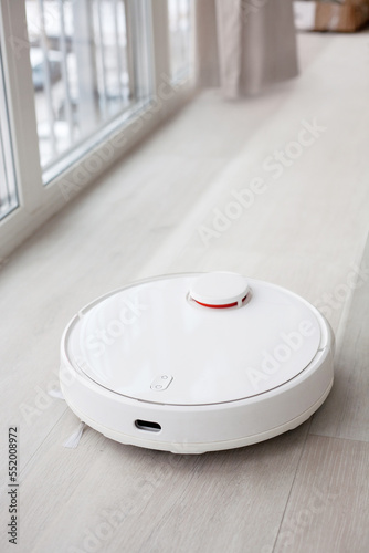 the robot vacuum cleaner mops the floor leaving the clean behind, smart home