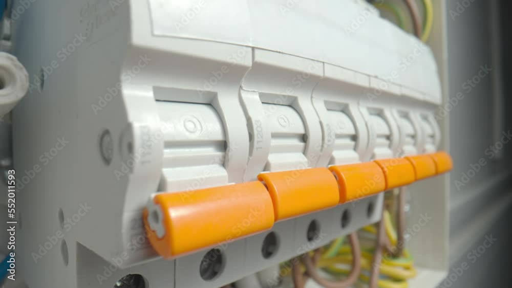 Circuit breaker switching. Close up of finger switching off high voltage electric power line