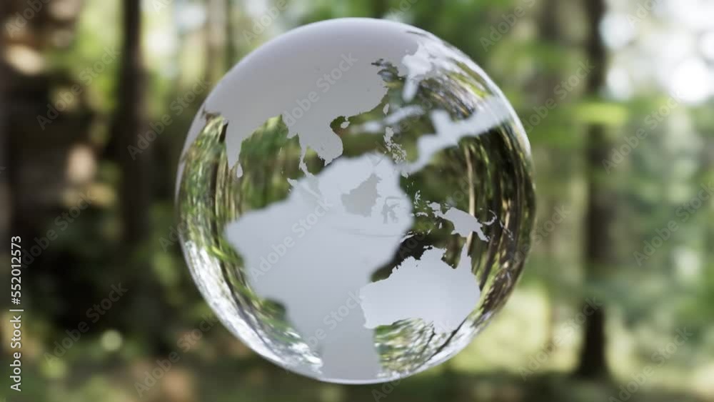 Rotating globe made of glass in a forest area - 3D Animation - 3D Rendering Rotating globe made of glass in a forest area - 3D Animation - 3D Rendering