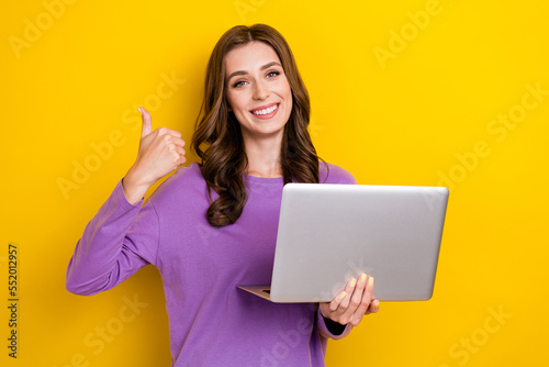 Portrait of positive person toothy smile demonstrate thumb up isolated on yellow color background