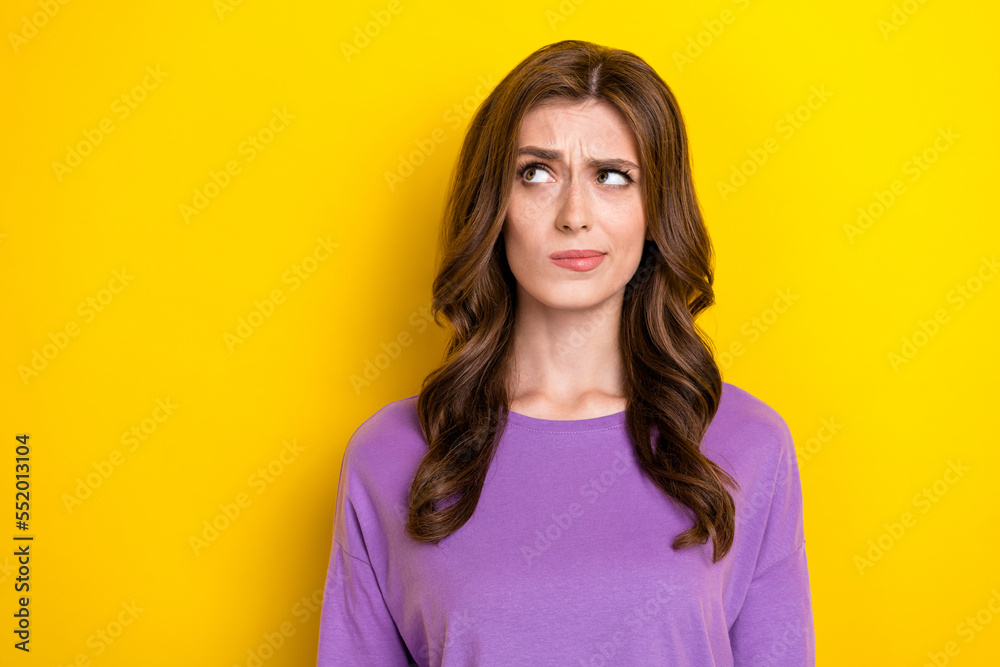 Portrait photo of young unsure minded deep think woman pouted lips look empty space dont know how app works isolated on yellow color background Portrait photo of young unsure minded deep think woman pouted lips look empty space dont know how app works isolated on yellow color background