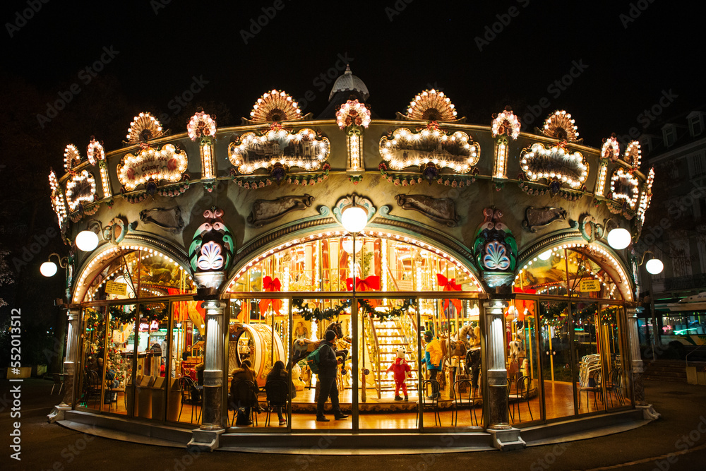 COLMAR, FRANCE - December 2016 - Carousel with Christmas decorations red bows and illuminations