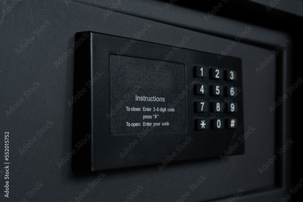 Black steel safe box with electronic security lock. Modern safety locker in a hotel room or at home. Black steel safe box with electronic security lock. Modern safety locker in a hotel room or at home.
