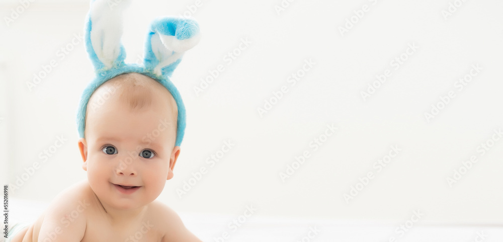 happy caucasian baby girl six months old wearing bunny ears headband happy caucasian baby girl six months old wearing bunny ears headband