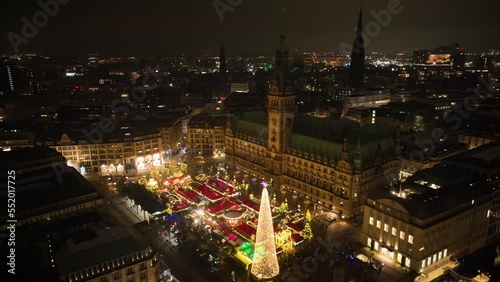 Aerial footage of Advent, Christmas in Hamburg. Rathaus, Christmas market, the decorated citycenter and a christmas tree installed in the center of the Alster lake. Atmosphere before the New Year photo