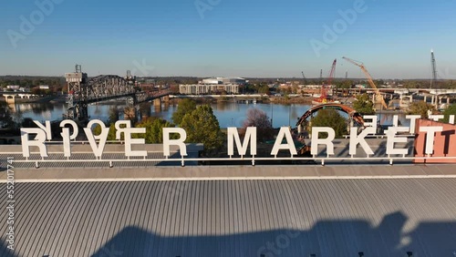 River Market in downtown Little Rock Arkansas. Rising aerial reveal of sign and Arkansas River and port. photo