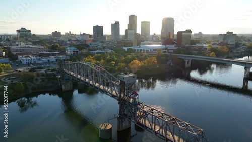 Little Rock Arkansas. Aerial of AR River and bridges with skyline in autumn sunset. Warm golden hour light. Establishing shot. photo