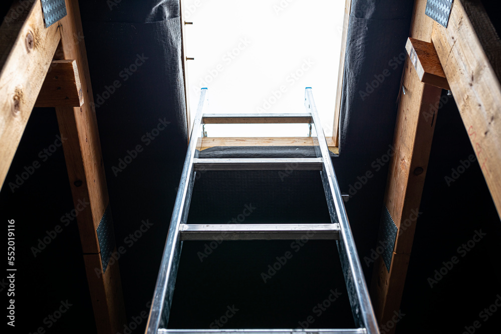 An open roof hatch in the attic for a chimney sweep, a standing ladder in the window.