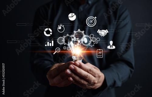 Businessman showing light bulb with business idea planning development leadership and customer target group, investment growth and success development, achievement, goal, strategy, finance concept.