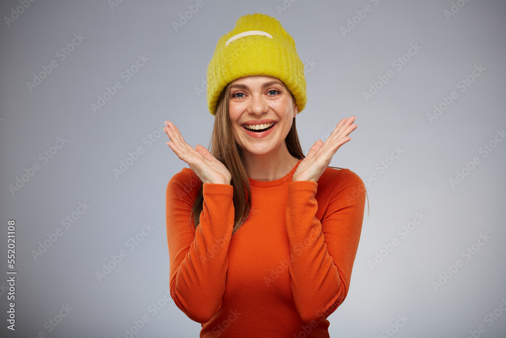 Happy surprising woman wearing yellow knitted hat. Isolated advertising portrait. Happy surprising woman wearing yellow knitted hat. Isolated advertising portrait.