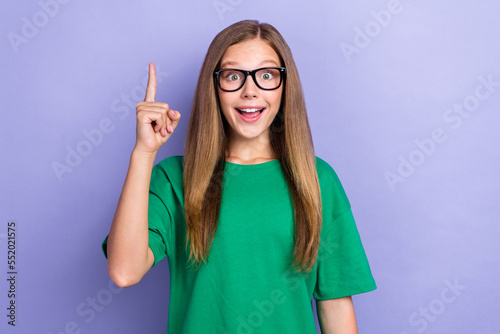 Photo of overjoyed pretty lady wear stylish clothes raise hand rejoice know answer lesson homework isolated on purple color background