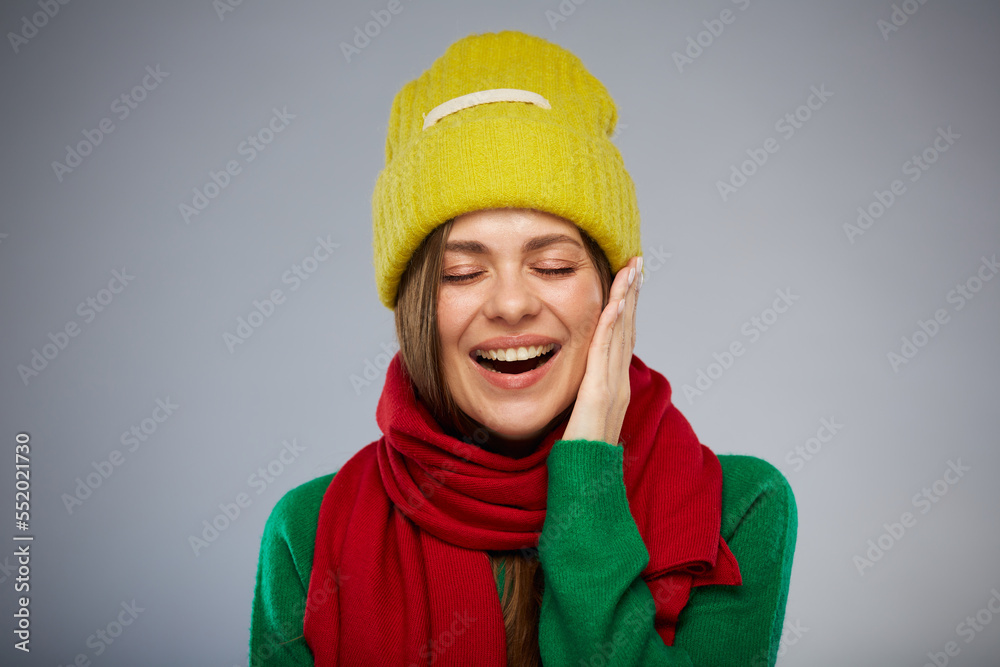 Happy surprising woman in casual warm clothes touching her face with closed eyes. Advertising female studio portrait. Happy surprising woman in casual warm clothes touching her face with closed eyes. Advertising female studio portrait.