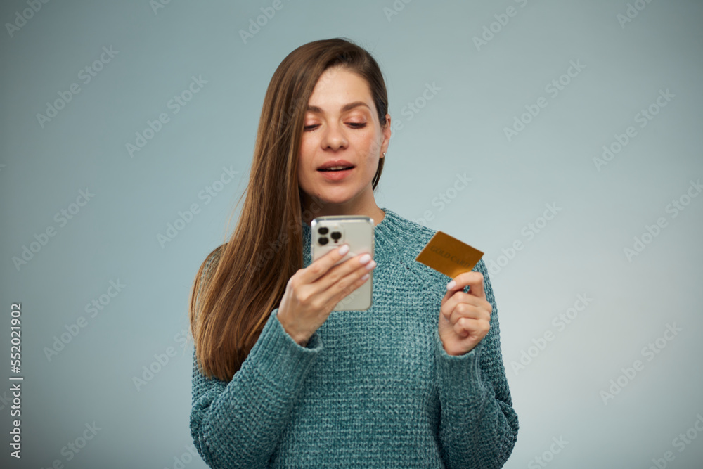 Happy woman using credit card and smartphone for online payment. Advertising female portrait. Happy woman using credit card and smartphone for online payment. Advertising female portrait.