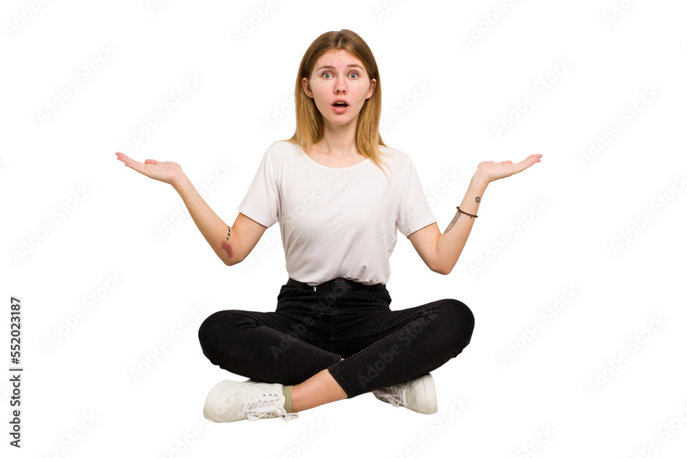 Young caucasian woman sitting on the floor cutout isolated Young caucasian woman sitting on the floor cutout isolated