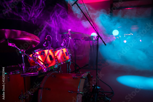 Drum Set on Stage with Colorful Lighting and Smoke in a Concert Venue