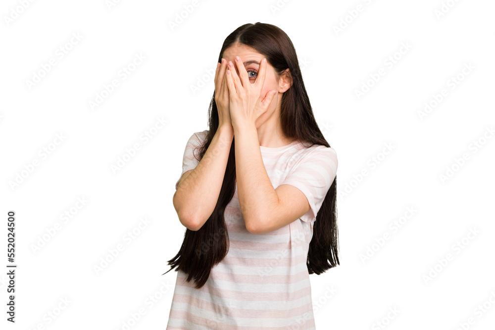 Young caucasian brunette long hair woman cutout isolated blink through fingers frightened and nervous. Young caucasian brunette long hair woman cutout isolated blink through fingers frightened and nervous.