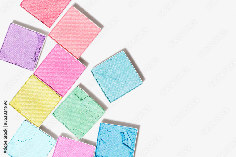 Vivid colored eye shadow makeup palette, pink, violet, blue, green colors on white background. Female cosmetic and beauty product, shiny eye shadow in package, aesthetic texture, copy space Vivid colored eye shadow makeup palette, pink, violet, blue, green colors on white background. Female cosmetic and beauty product, shiny eye shadow in package, aesthetic texture, copy space