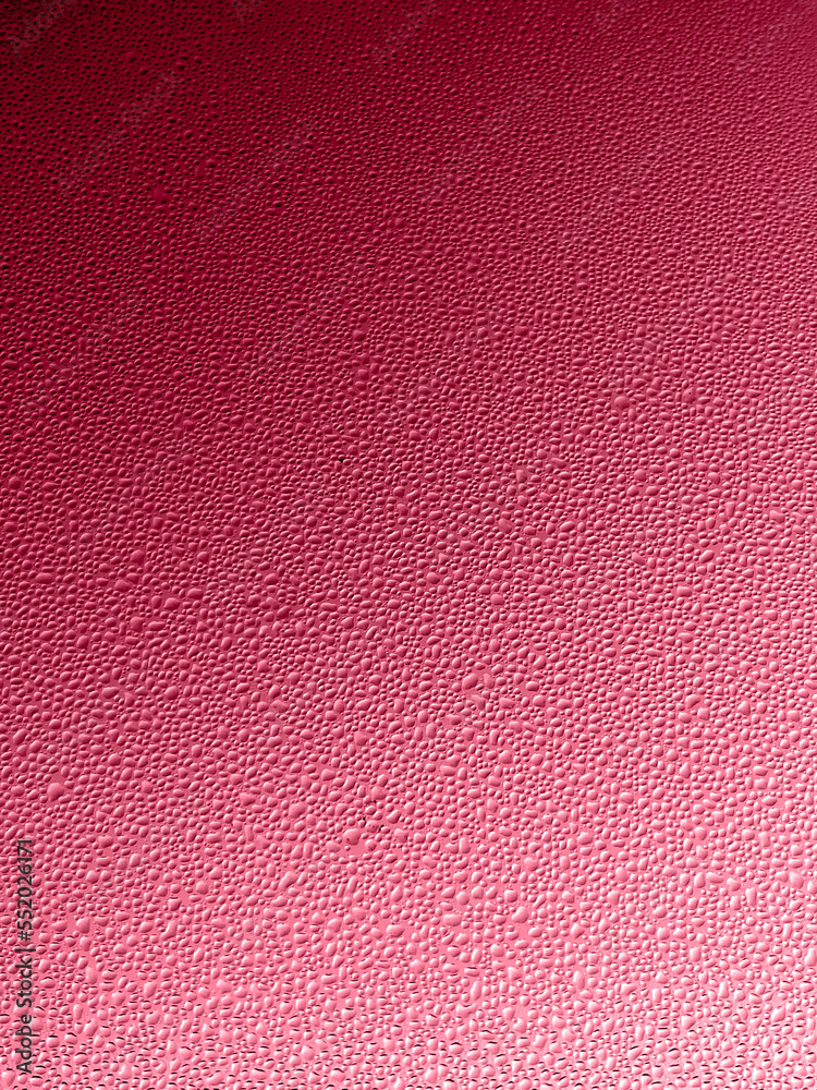Fototapeta premium Trendy color 2023 viva magenta red toned abstract water drops on glasses window gradient background