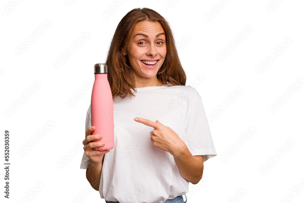 Young caucasian woman holding a pink thermo isolated smiling and pointing aside, showing something at blank space. Young caucasian woman holding a pink thermo isolated smiling and pointing aside, showing something at blank space.