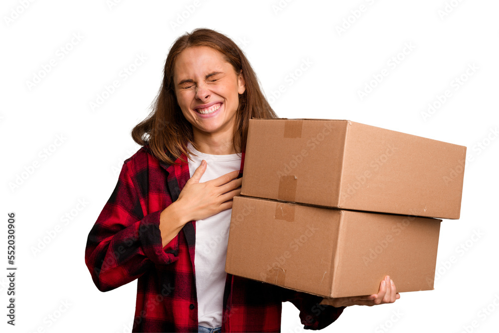 Young caucasian woman moving while picking up a box full of things isolated laughs out loudly keeping hand on chest. Young caucasian woman moving while picking up a box full of things isolated laughs out loudly keeping hand on chest.