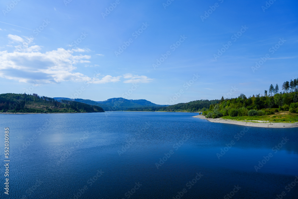 View of the Grane reservoir with the surrounding nature near Goslar. Landscape at the Granetalsperre in the Harz Mountains.
