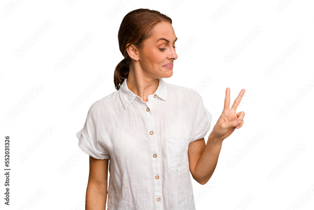 Young caucasian woman isolated joyful and carefree showing a peace symbol with fingers. Young caucasian woman isolated joyful and carefree showing a peace symbol with fingers.