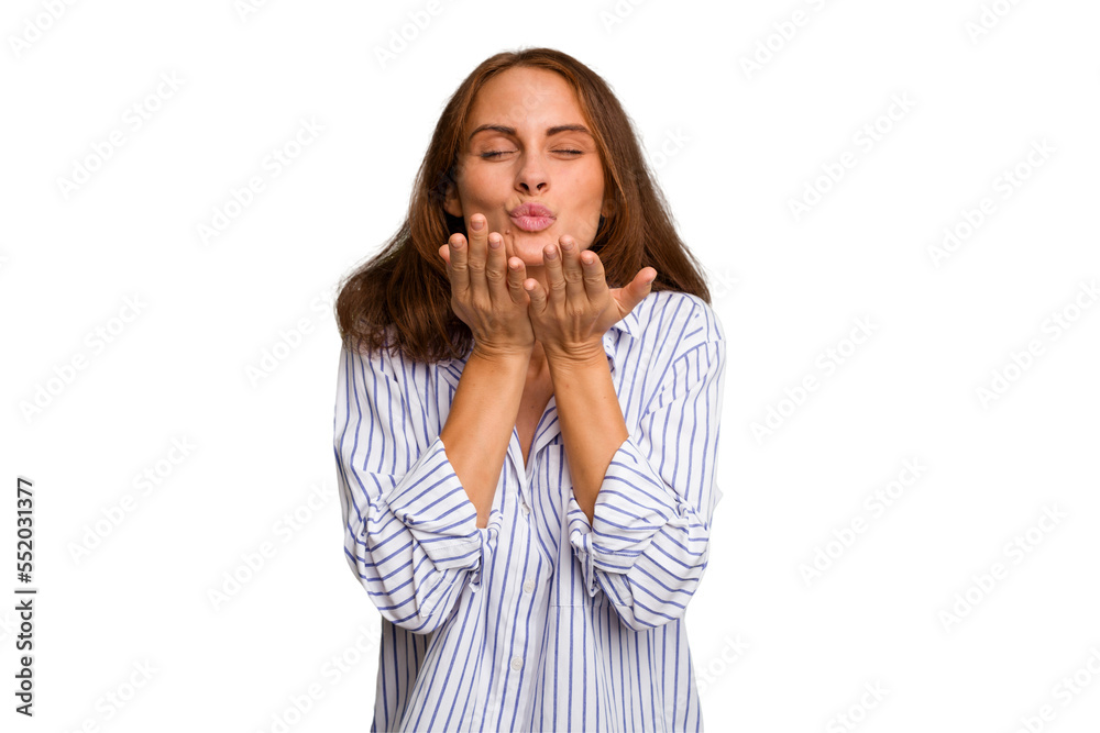 Young caucasian woman isolated folding lips and holding palms to send air kiss. Young caucasian woman isolated folding lips and holding palms to send air kiss.