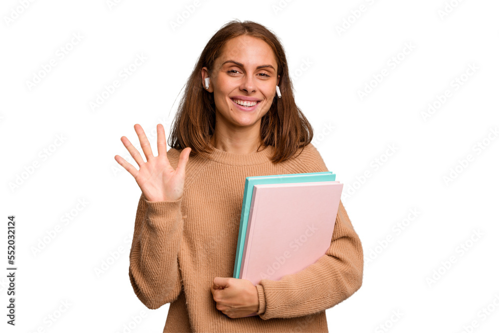 Young student woman holding a books isolated smiling cheerful showing number five with fingers. Young student woman holding a books isolated smiling cheerful showing number five with fingers.