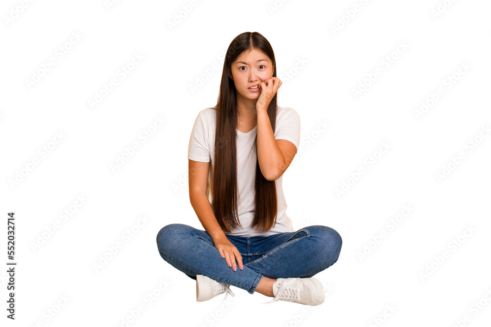 Young asian woman sitting on the floor cutout isolated biting fingernails, nervous and very anxious. Young asian woman sitting on the floor cutout isolated biting fingernails, nervous and very anxious.