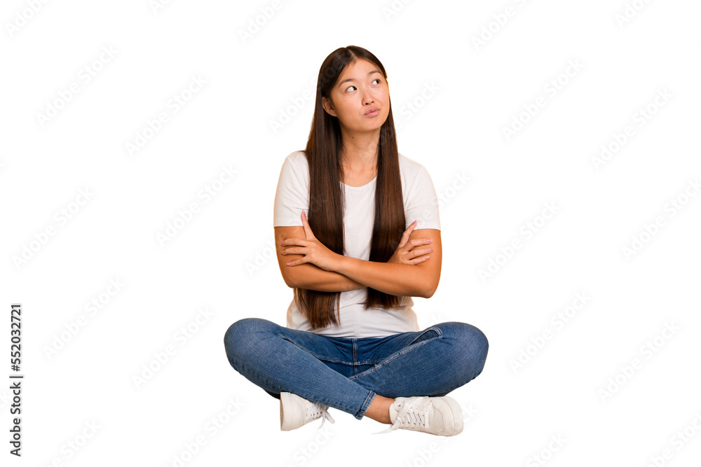 Young asian woman sitting on the floor cutout isolated dreaming of achieving goals and purposes Young asian woman sitting on the floor cutout isolated dreaming of achieving goals and purposes