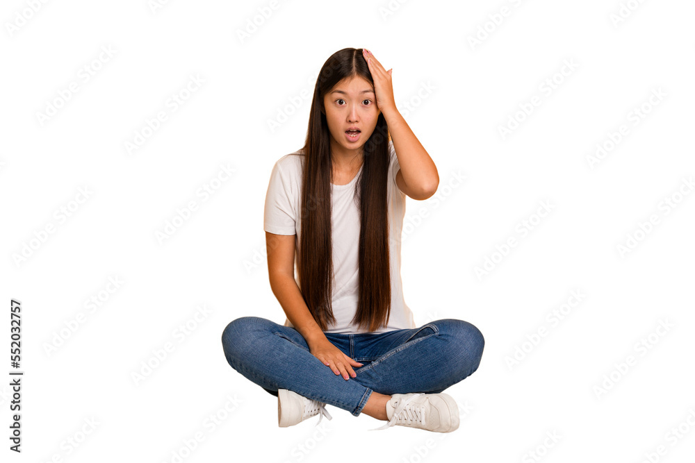 Young asian woman sitting on the floor cutout isolated being shocked, she has remembered important meeting. Young asian woman sitting on the floor cutout isolated being shocked, she has remembered important meeting.