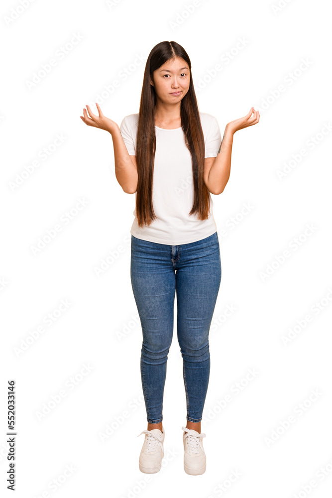 Young asian woman standing, full body cutout isolated doubting and shrugging shoulders in questioning gesture. Young asian woman standing, full body cutout isolated doubting and shrugging shoulders in questioning gesture.