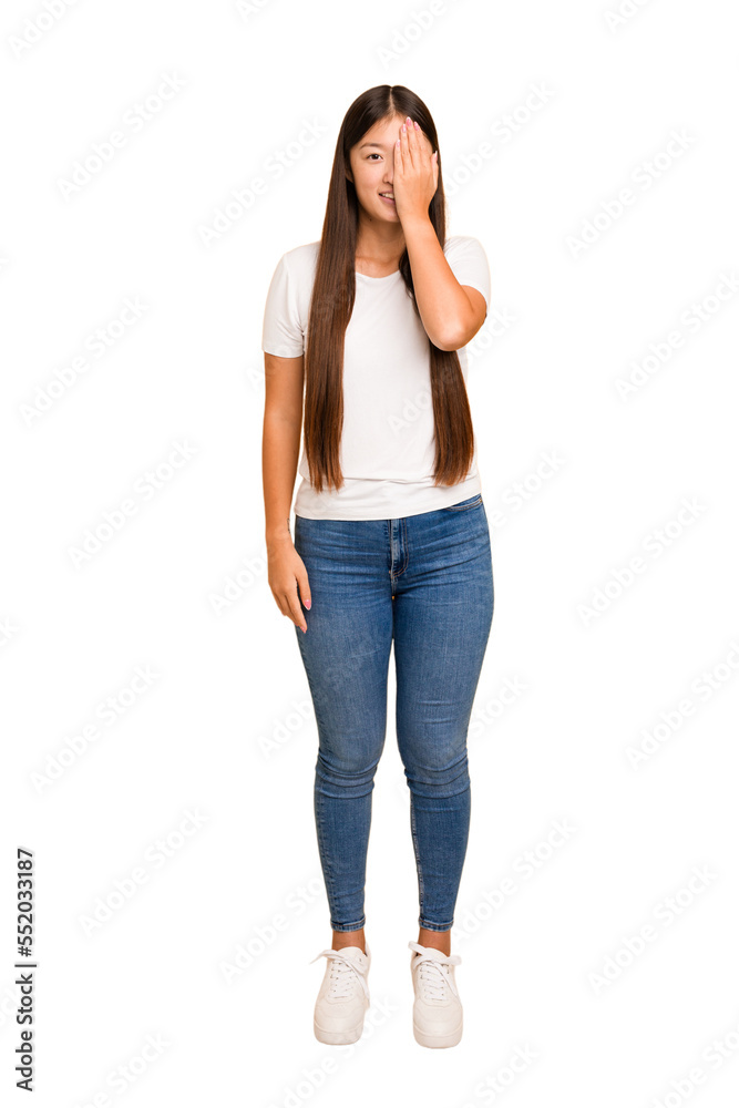 Young asian woman standing, full body cutout isolated having fun covering half of face with palm. Young asian woman standing, full body cutout isolated having fun covering half of face with palm.