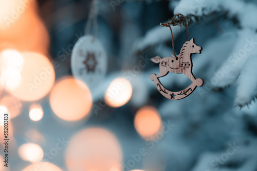 Happy holidays, Merry Christmas, Cute christmas decoration on a coniferous tree covered with snow in the middle of the forest © Dominik