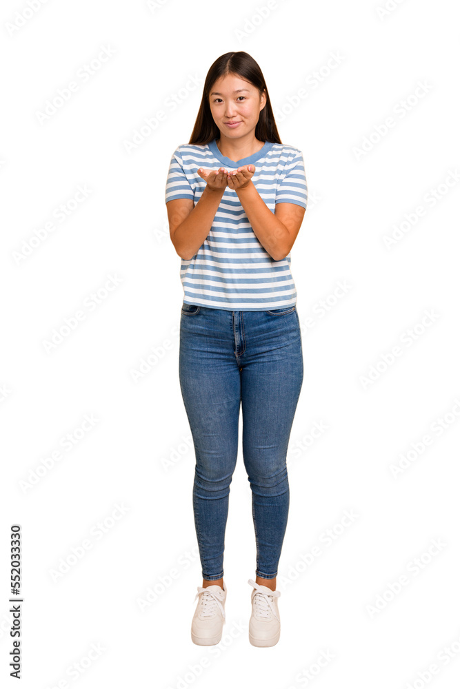 Young asian woman standing, full body cutout isolated holding something with palms, offering to camera. Young asian woman standing, full body cutout isolated holding something with palms, offering to camera.