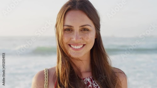 Portrait, woman and smile with at beach, summer vacation and travel on holiday in sunshine outdoors in Australia. Happy face, laughing and girl relax at sea, ocean and freedom, wellness and nature photo