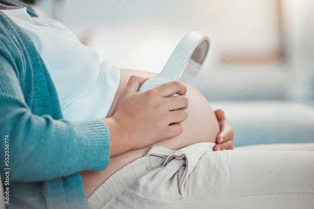 Fototapeta premium Relax, pregnant woman and headphones on stomach, music playing for baby in living room. Pregnancy, earphones on belly and technology, woman on sofa streaming audio sound for child listening in utero.