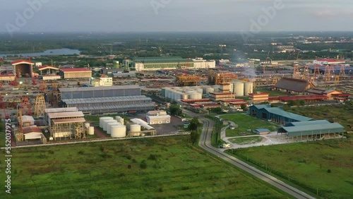Aerial slow zoom out shot capturing PGEO edible oil refinery food processing centre and sapura energy fabrication yard at lumut port industrial park, Kampung Acheh, Sitiawan, Perak, Malaysia. photo