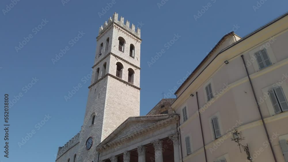 View on the medieval tower located next to Temple of Minerva in the Piazza del Comune in Assisi. Assisi is located in Umbria, region part of central Italy. Dolly move. View on the medieval tower located next to Temple of Minerva in the Piazza del Comune in Assisi. Assisi is located in Umbria, region part of central Italy. Dolly move.