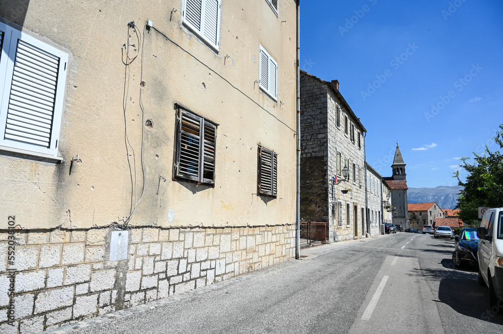 Vrlika, Croatia. Buildings and street in the center of town.