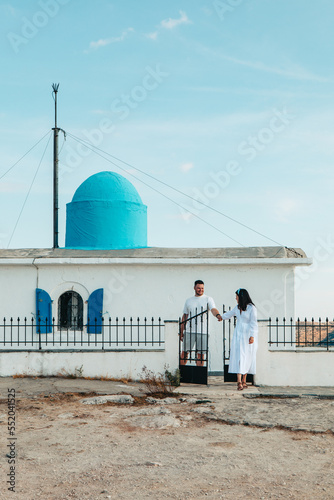 happy couple travelers in front of Church of the Prophet Elias