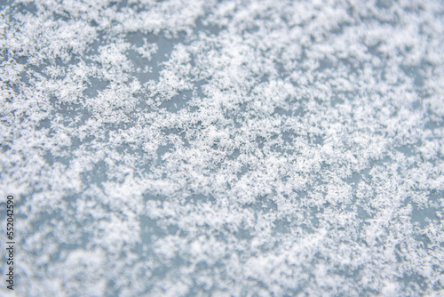 Winter snow background.Frosted background.Abstract frosty pattern on glass.Frosty patterns on the glass with empty space for text.
