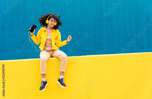 Young happy woman dancing and having fun outdoor