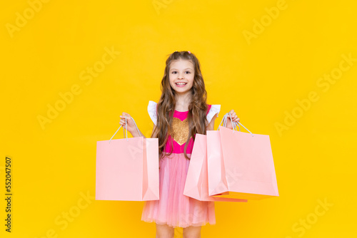 Big discounts in stores for children, new purchases for spring, a little girl is preparing in spring and shopping in stores.