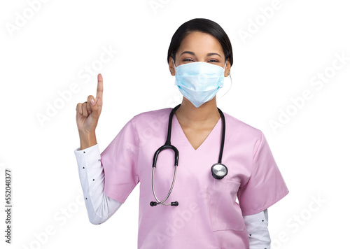 PNG cropped portrait of an attractive young female healthcare worker wearing a mask and pointing towards copyspace in studio.