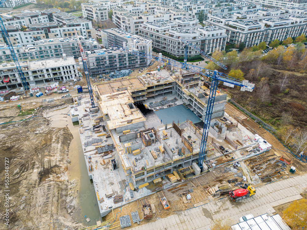 Aerial view of construction site with crane and building. Top view of big development construction and architecture.