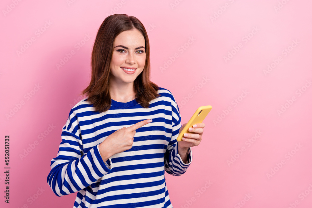 Photo of cheerful pretty lady user wear trendy clothes recommend cool device sale empty space isolated on pink color background