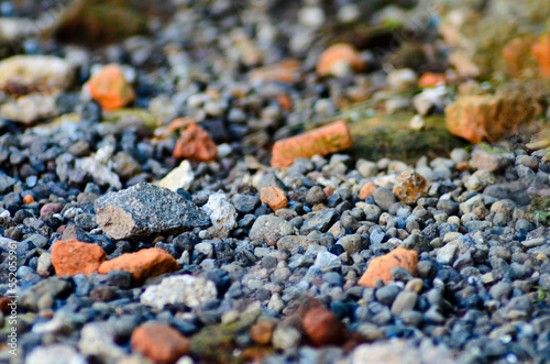 sharp bluish pebbles on a cobbled road. selective focus. stones in the sand