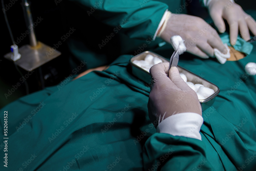 A team of professional doctors perform surgery in a hospital, a group of surgeons working in the operating theater. A team of professional doctors perform surgery in a hospital, a group of surgeons working in the operating theater.